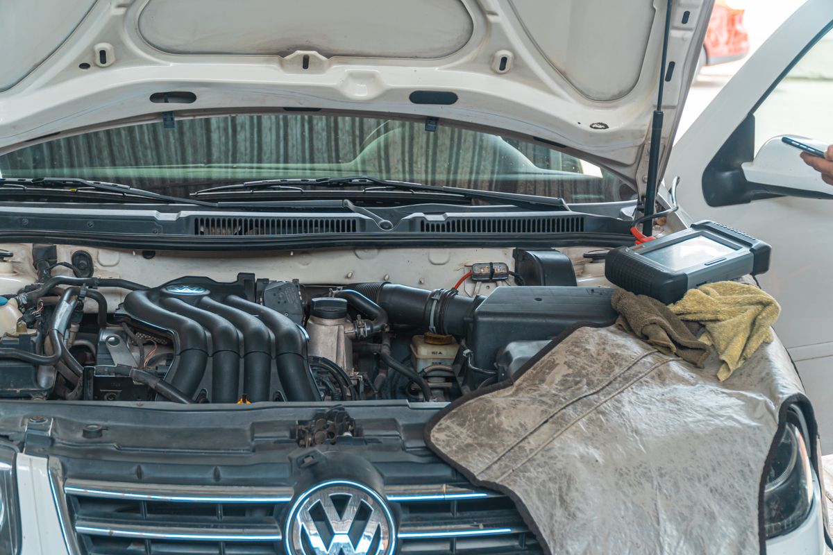 Car engine bay being checked before autumn