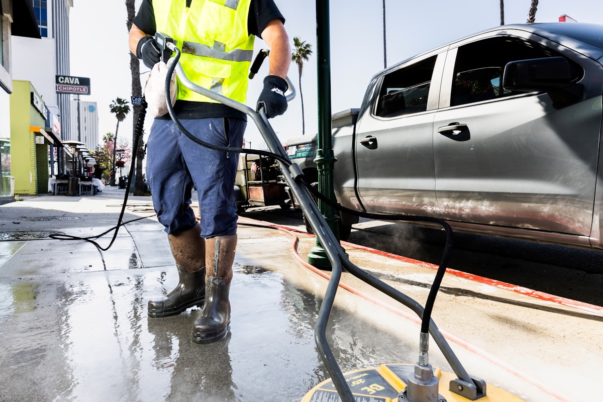 Pressure washers lined up on a patio with cleaning equipment
