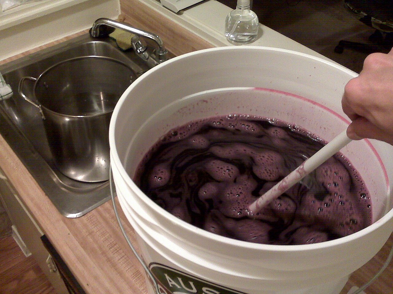 Home winemaking must mixture fermenting in a large pot, ready for bottling