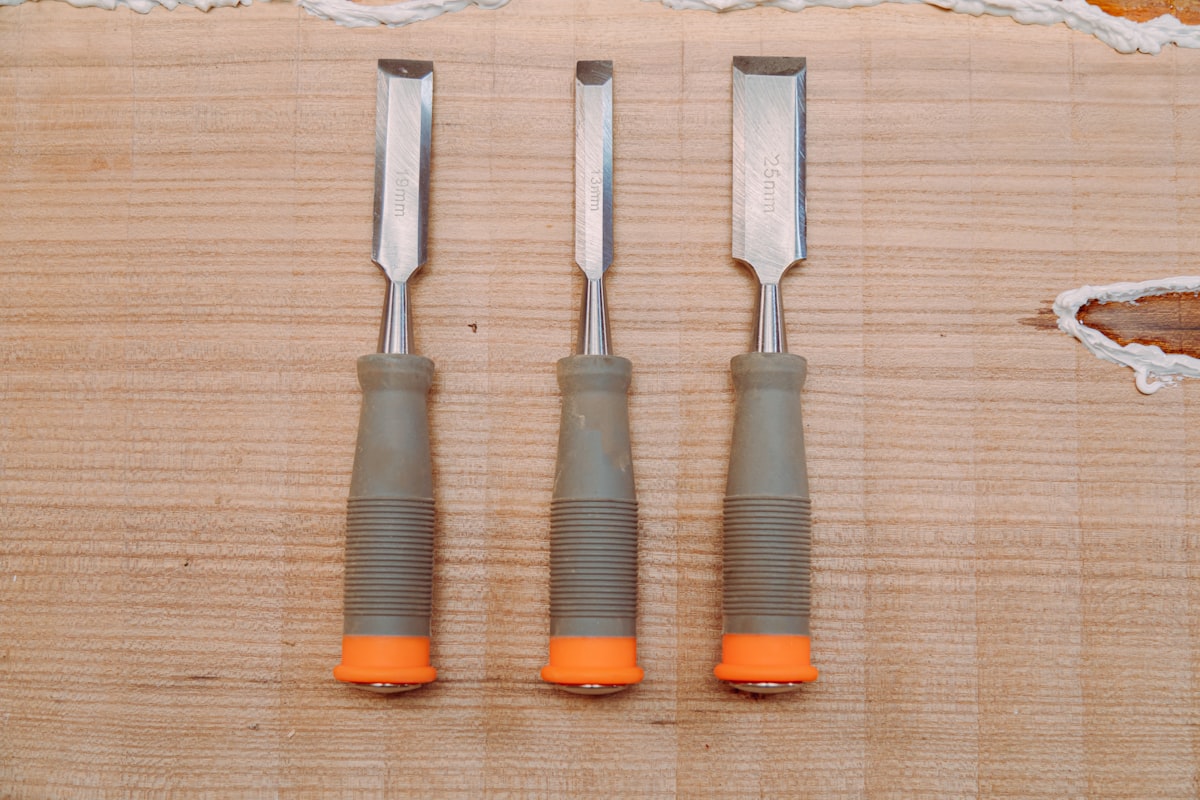 Wood chisels on a workshop workbench with carving tools