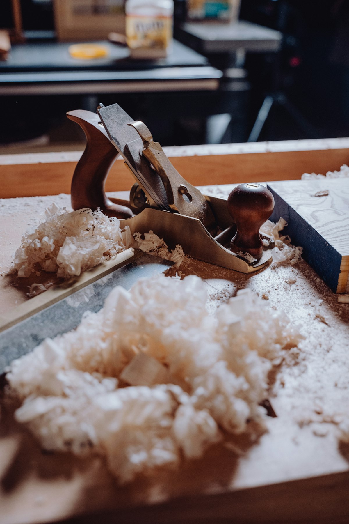 Electric planer and hand plane on a wooden workbench with wood shavings