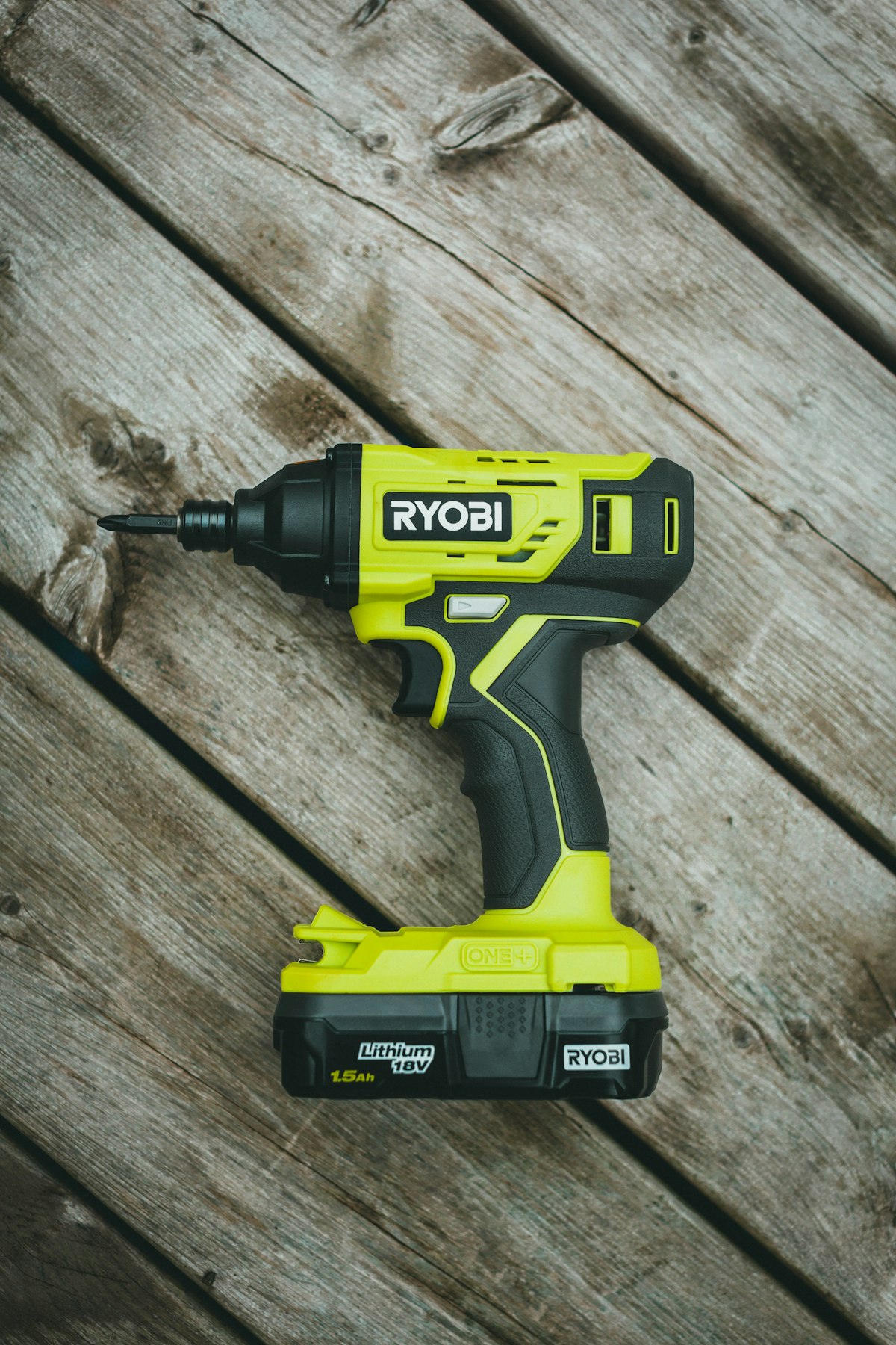 Cordless drill on a wooden workbench ready for drilling into brick