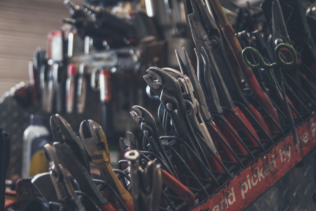 Hand tools arranged on a workshop workbench ready for dry storage