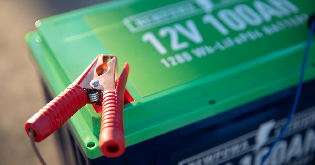 Jumper cables clipped to a car battery ready for a safe jump start