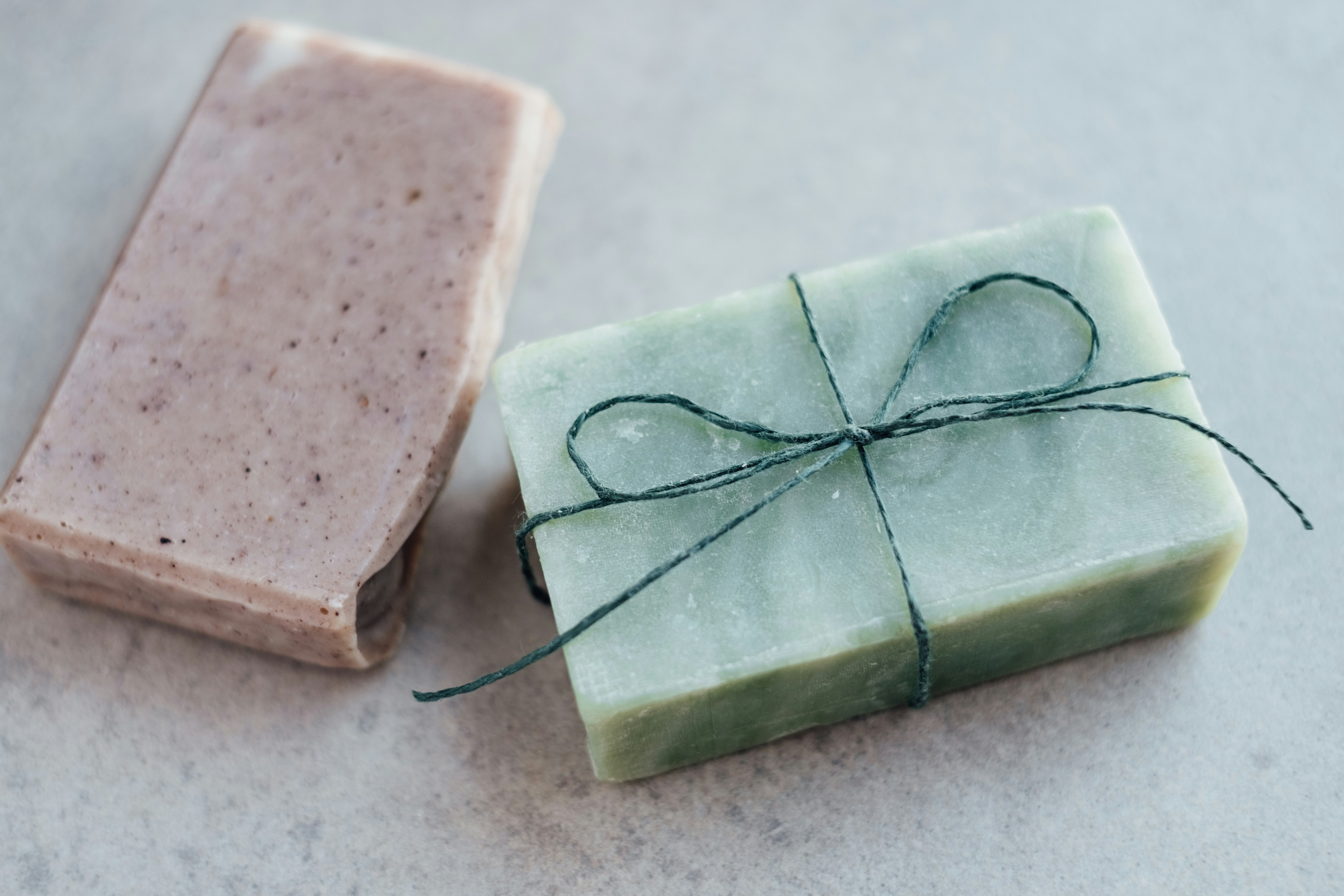 Handmade melt and pour soap bars with silicone moulds on a kitchen worktop